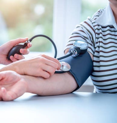 Nurse checking a patient's blood pressure